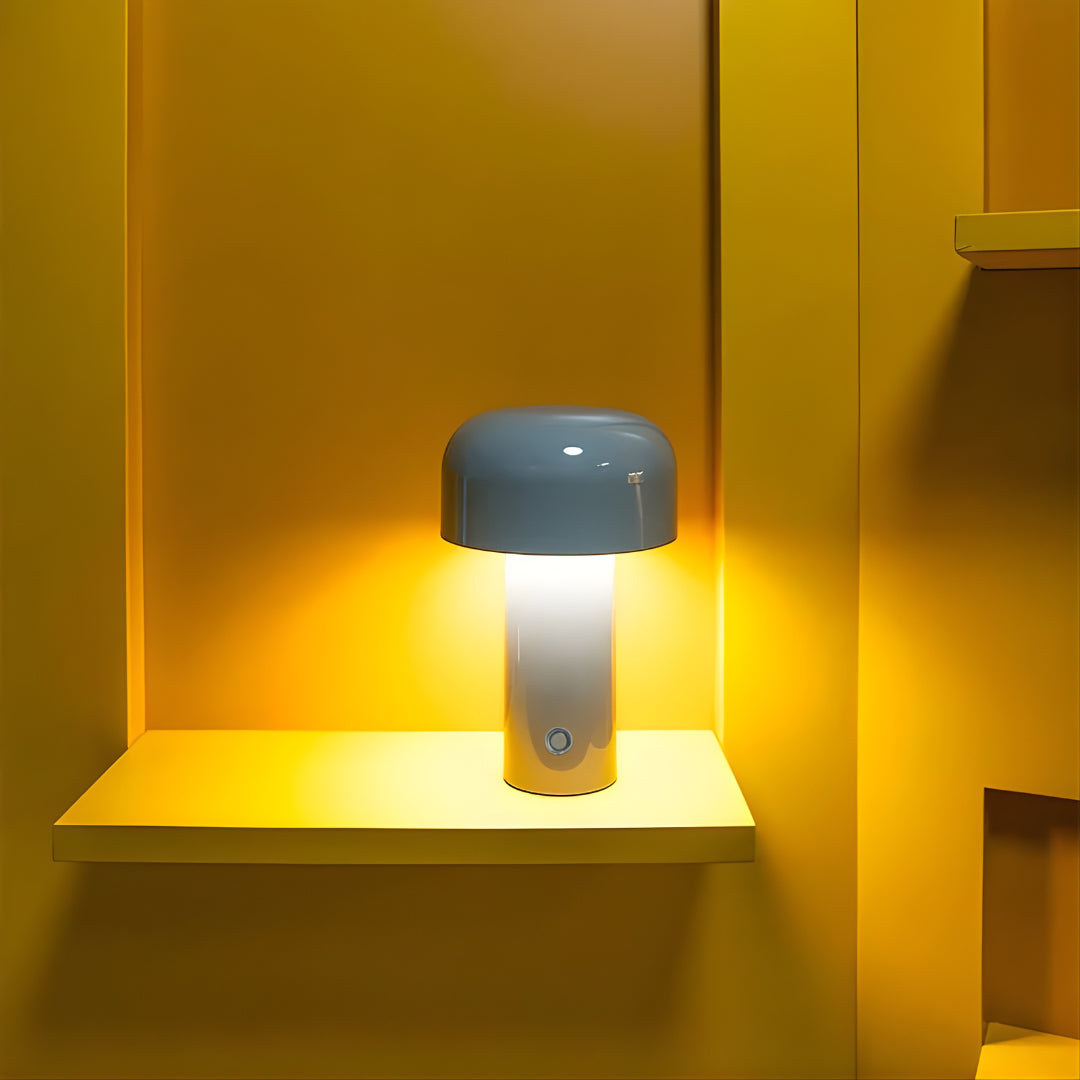 Small lamp with a blue shade on a yellow shelf against a yellow wall