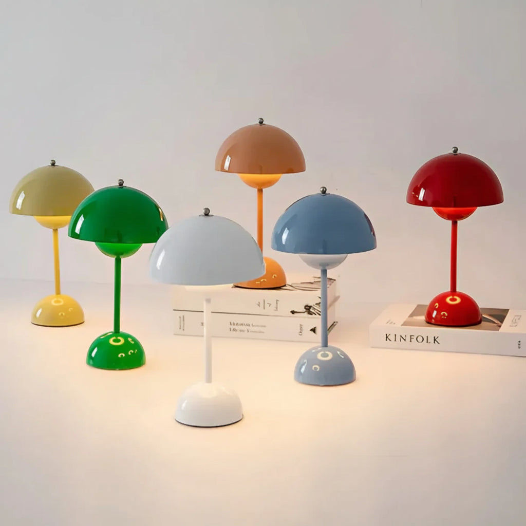 Set of colorful table lamps on a light surface with a neutral background